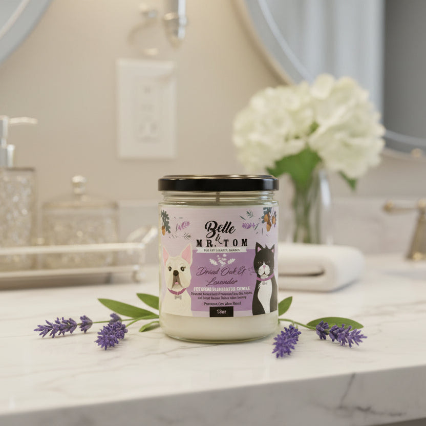 Belle & Belle candle on a bathroom counter with flowers and soap dispenser in the background