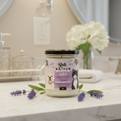 Belle & Belle candle on a bathroom counter with flowers and soap dispenser in the background